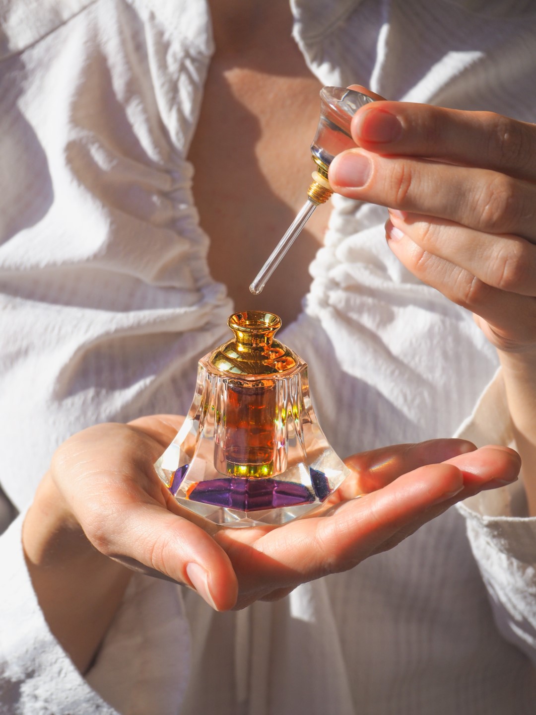 Arabian oud attar perfume or agarwood oil fragrances in crystal bottle.