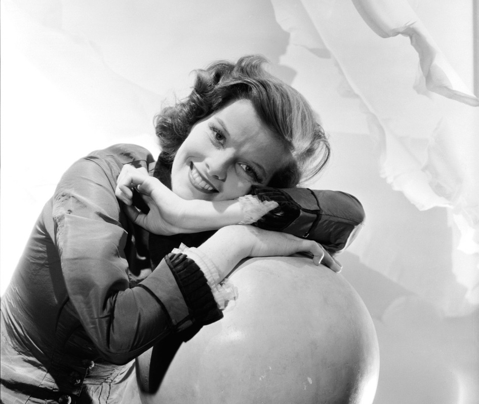 Portrait of actress Katharine Hepburn resting her head on a sphere. Katharine Hepburn;