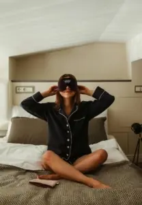 Ženska se pripravlja na spanje s spalno masko